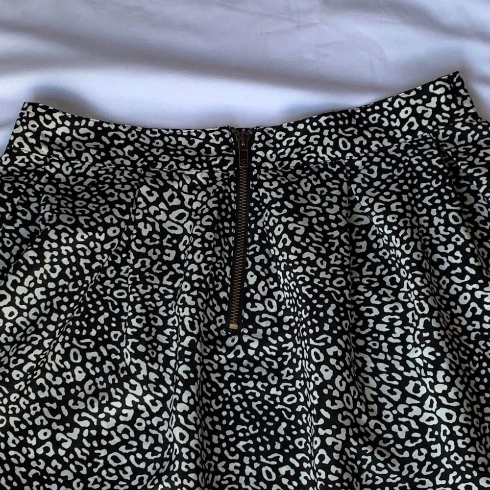 Above the knee black and white skirt